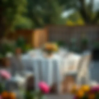 An outdoor setting featuring a beautifully decorated round table with a plastic tablecloth.