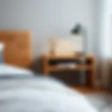 Elegant wooden C table with a minimalist design, complemented by a modern bedside lamp.