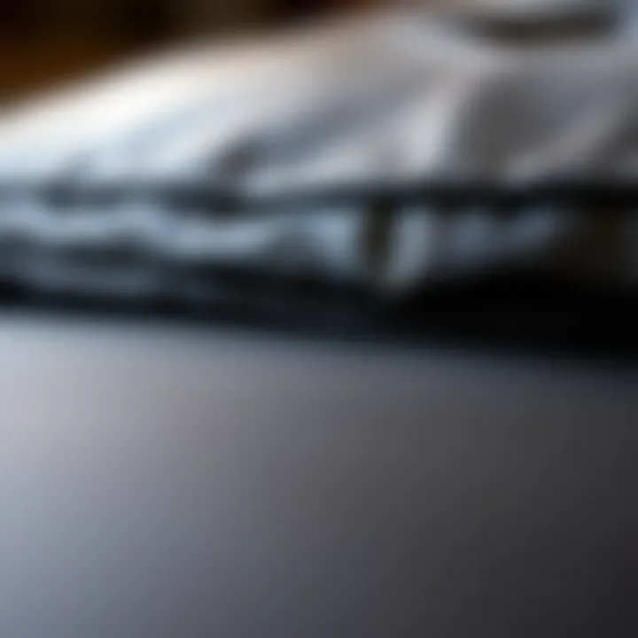 Close-up of the texture and stitching of a black leather ottoman